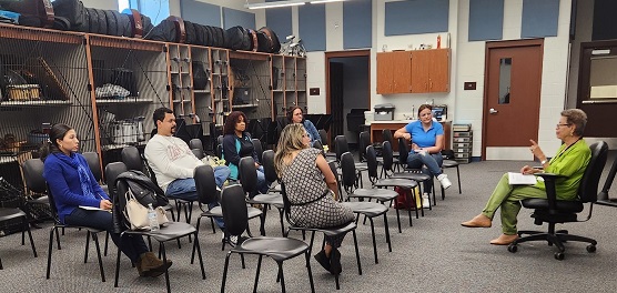 A group of people sitting in chairsDescription automatically generated with medium confidence